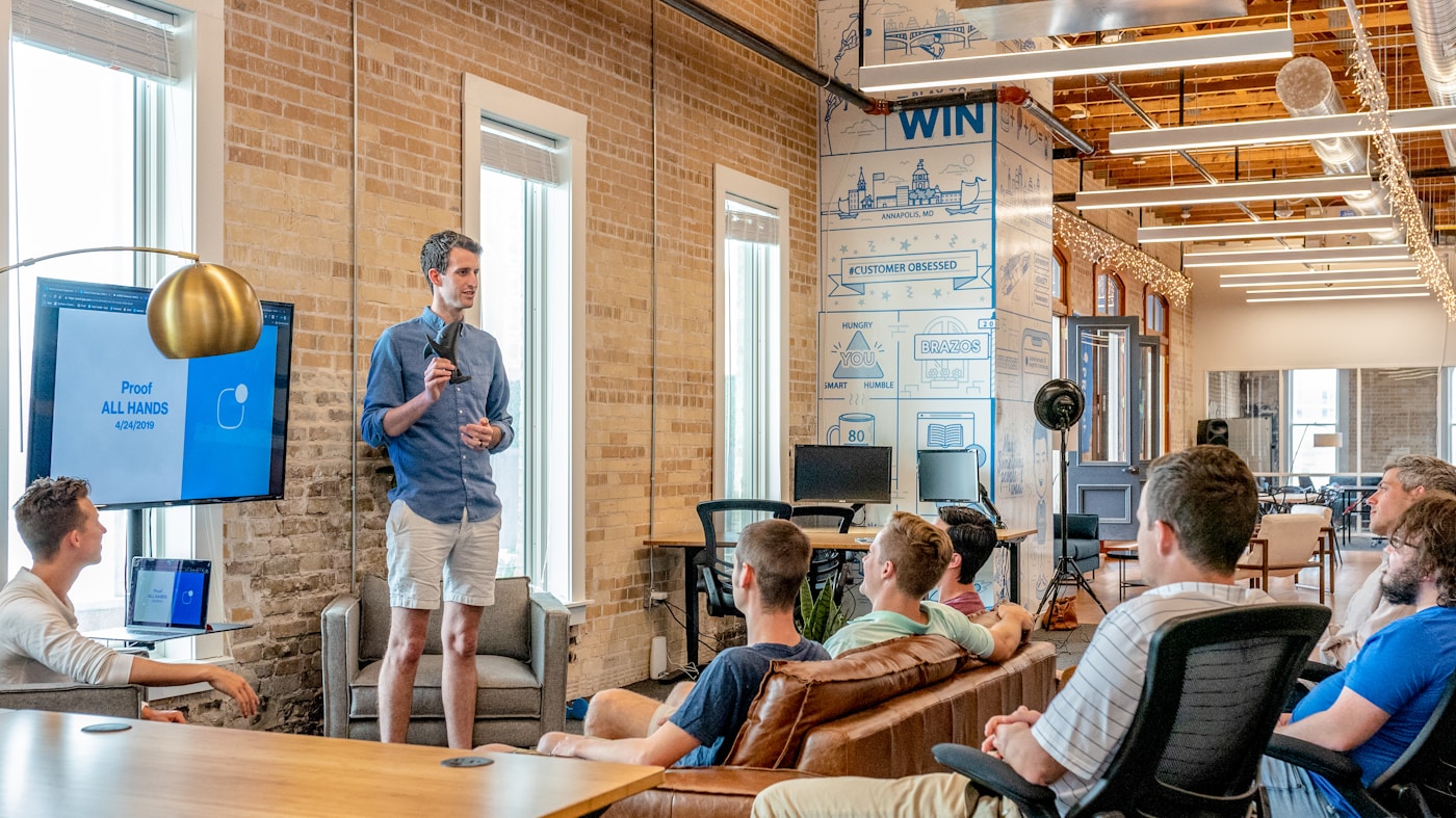 Marketing team conducting a pitch direction workshop around a conference table in a modern agency studio